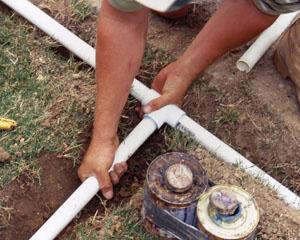 a Desoto Sprinkler Repair tech installs a replacement t joint
